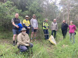 Seven people standing for a photo in the Haldane Reserve after walking the reserve to discuss potential ways to get more community members interested in the reserve.