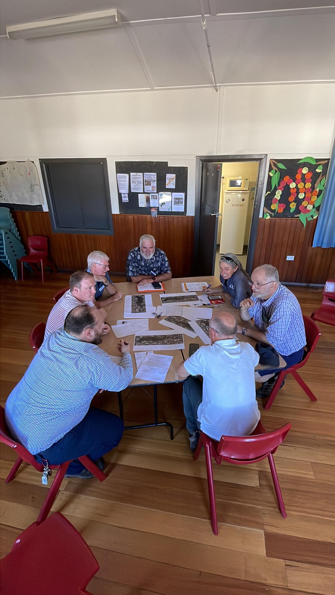 Seven interested community members and City of Hobart staff sitting around a table discussing ideas for the future of the Haldane Reserve.